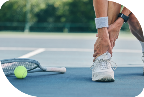 pickleball player holding ankle in pain