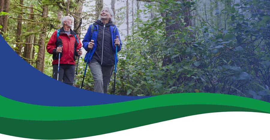 older couple hiking on a trail