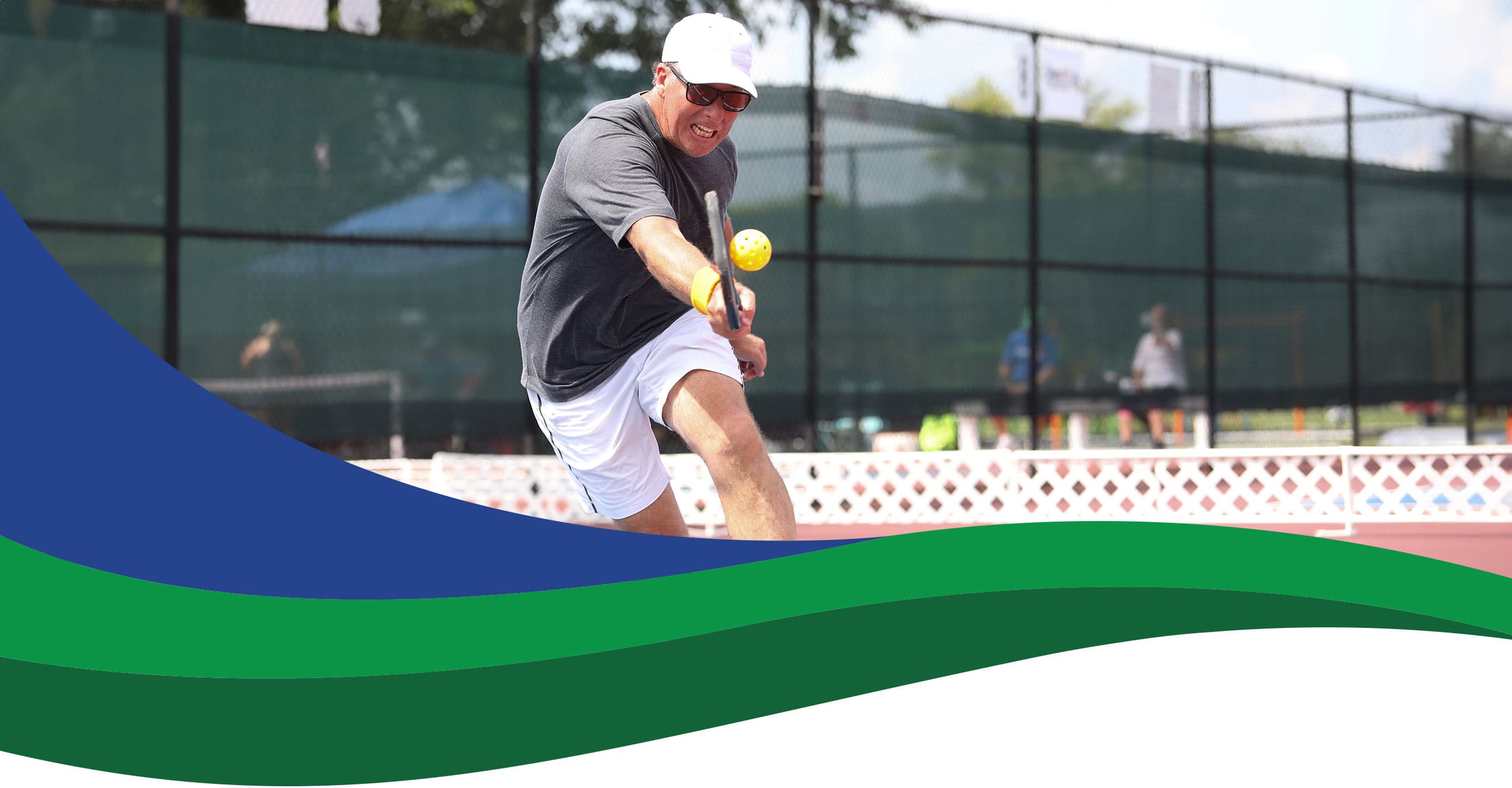 man playing pickleball in mid-swing