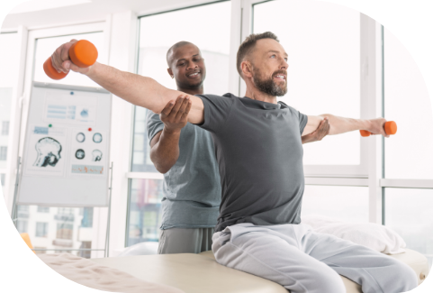 therapist helping patient lift weights