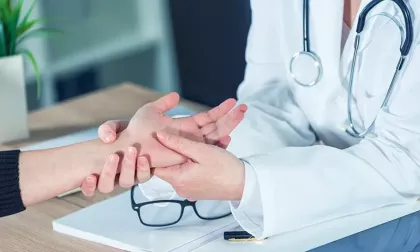 doctor examining patient's hand