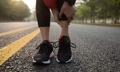 athlete holding ankle in pain