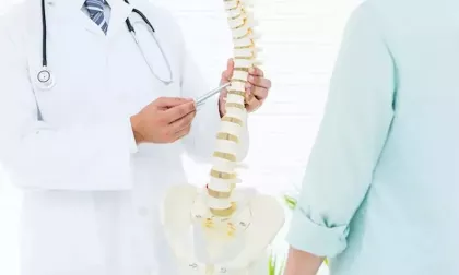 doctor showing spine model