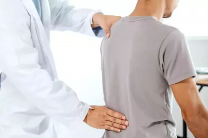 doctor examining patient's back