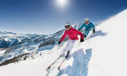 couple skiing downhill