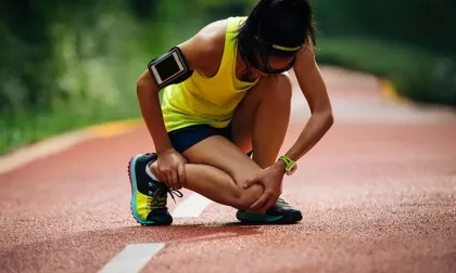 athlete holding injured leg