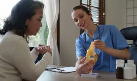 nurse explaing joint replacement with model