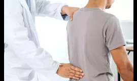 doctor examining patient's back