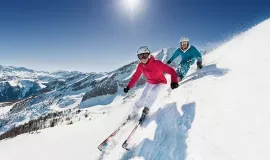 couple skiing downhill